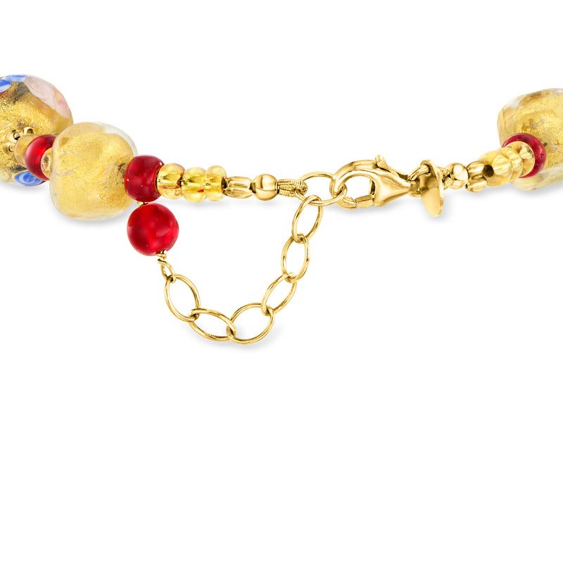 Gold-tone bead bracelet with oval glass beads, red accents, and toggle clasp