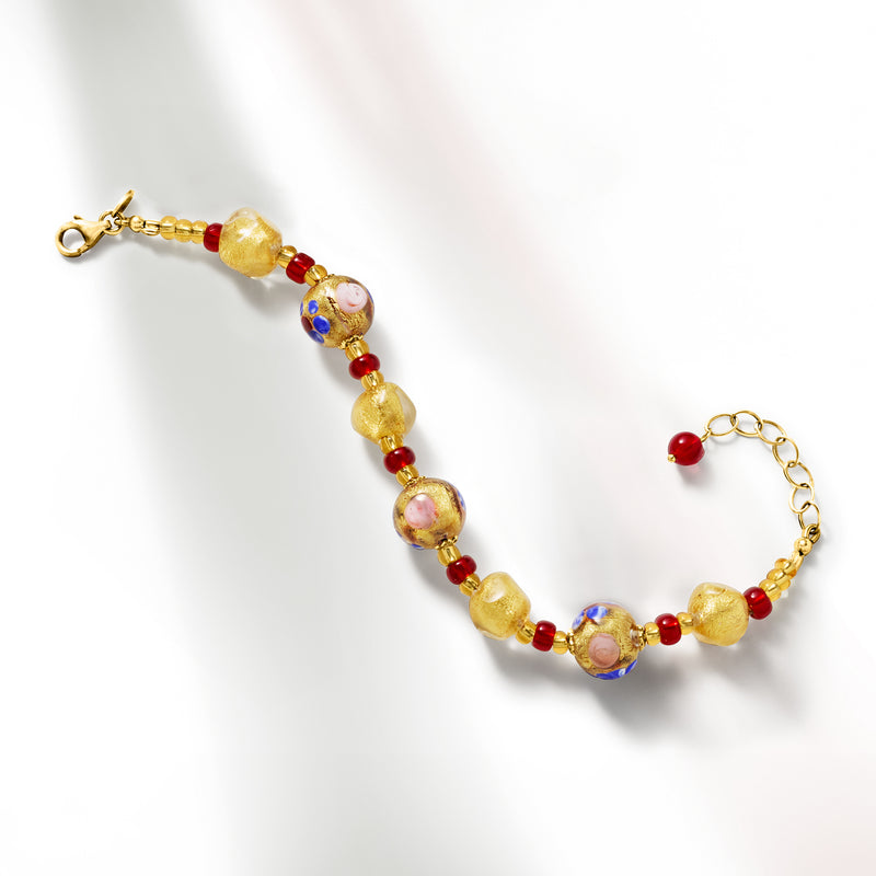 Gold-tone Murano glass bead bracelet laid flat with red, blue, and pink round beads