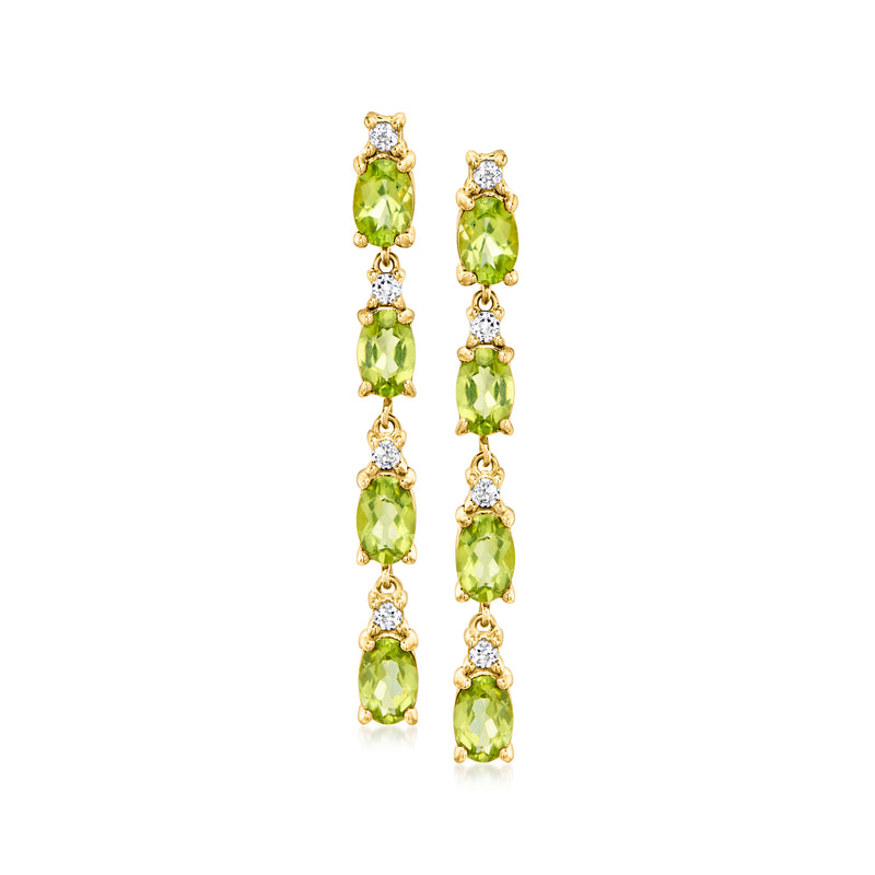 Gold drop earrings with green peridot oval stones and small white topaz accents
