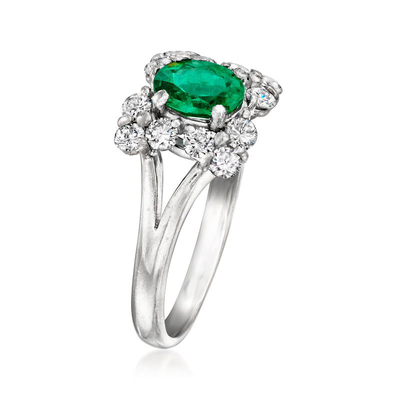 Platinum ring view: oval green gemstone center with diamond clusters on both sides