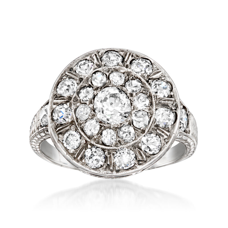 Vintage white gold diamond cluster ring with round center stone and halo of small diamonds