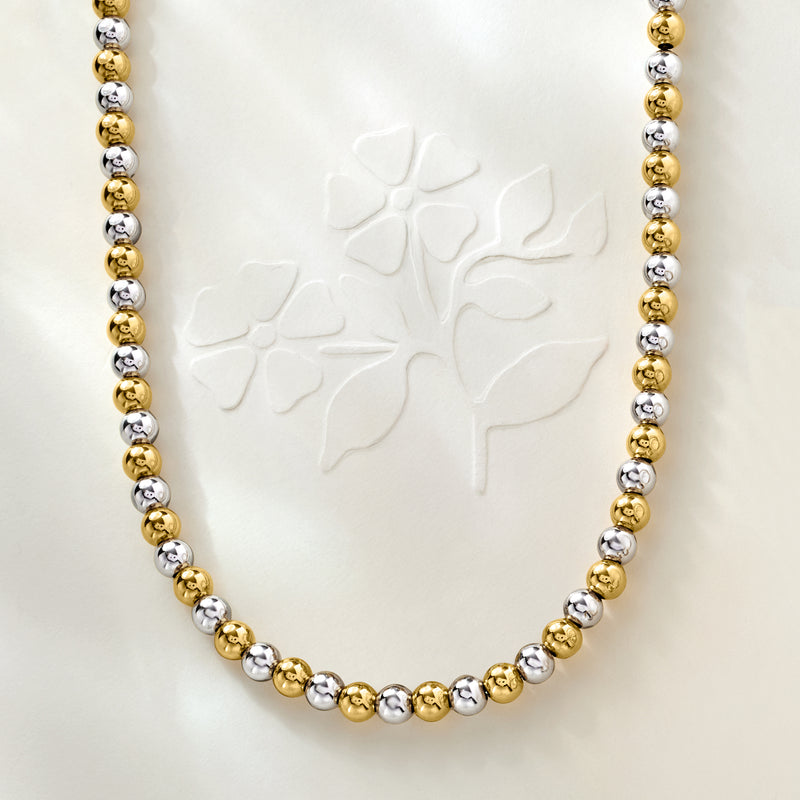 Alternating gold and silver round bead necklace on a sterling silver chain