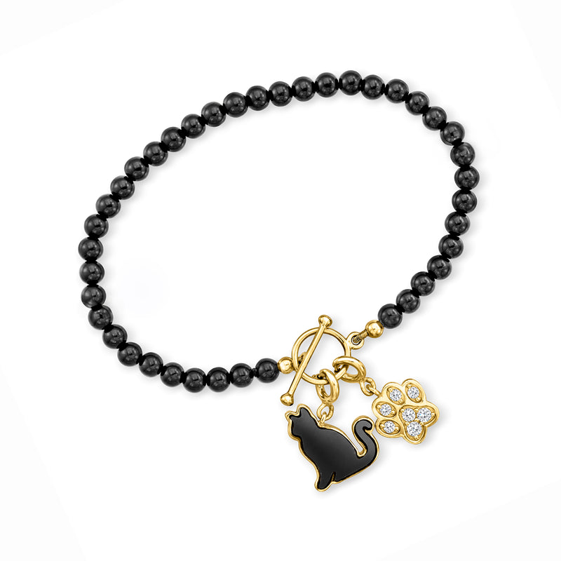 Black onyx bead bracelet with gold toggle clasp and small paw charm with rhinestones