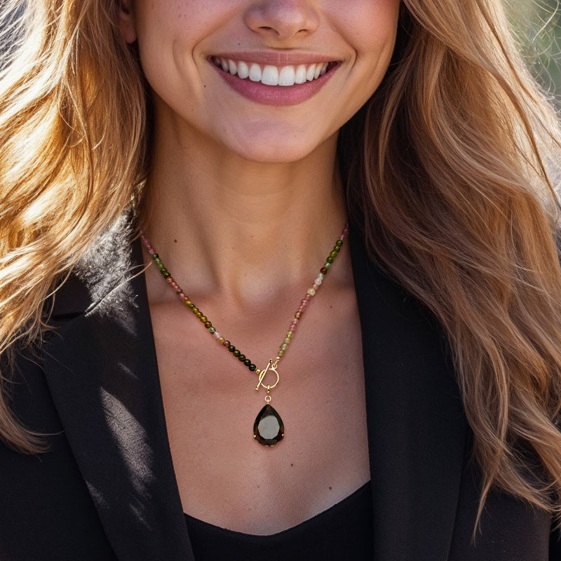 Gold-tone smoky quartz teardrop charm pendant on beaded necklace chain