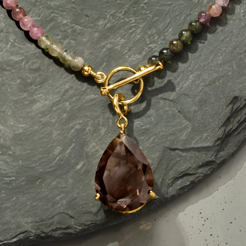 Smoky quartz teardrop charm pendant with gold setting on beaded necklace