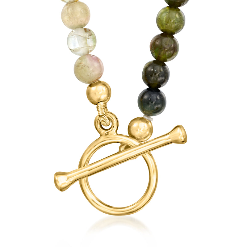 Tourmaline bead necklace close-up of gold toggle clasp with multicolored beads.