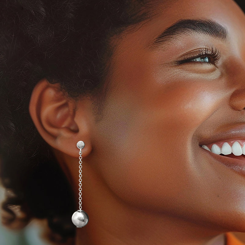 Sterling silver bead drop earrings worn on ear, round drop beads on chain