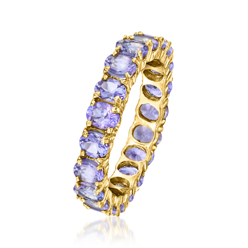 Gold tanzanite-colored oval gemstone eternity band ring, side view with raised prongs