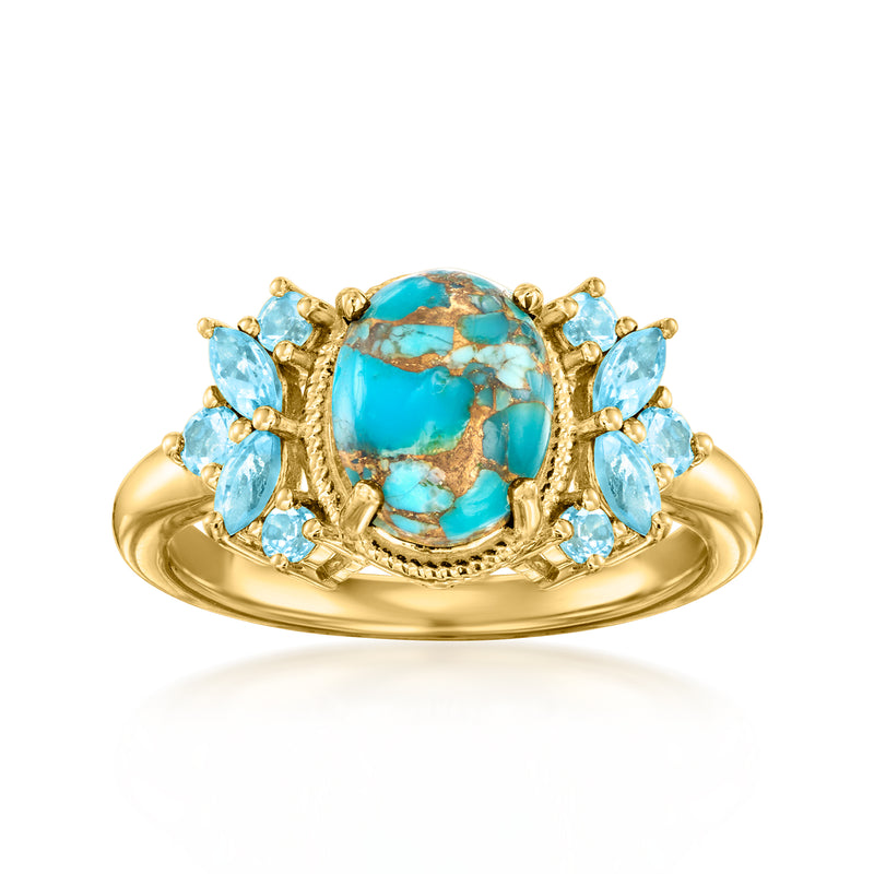 Gold oval ring with turquoise center stone and light blue side stones, halo setting