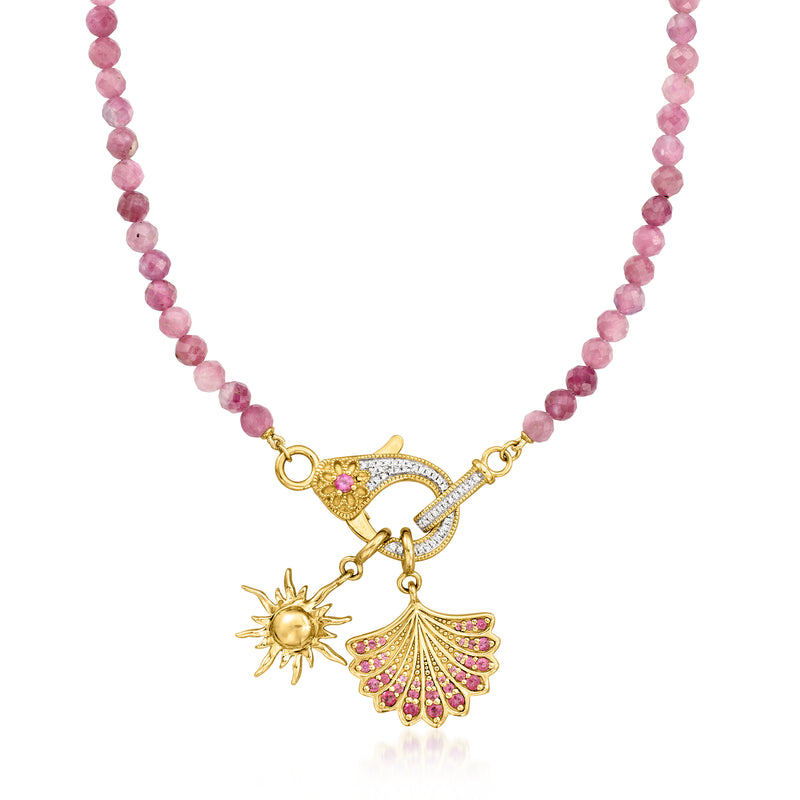 Pink bead necklace with gold lobster clasp, starburst charm, and pink fan pendant