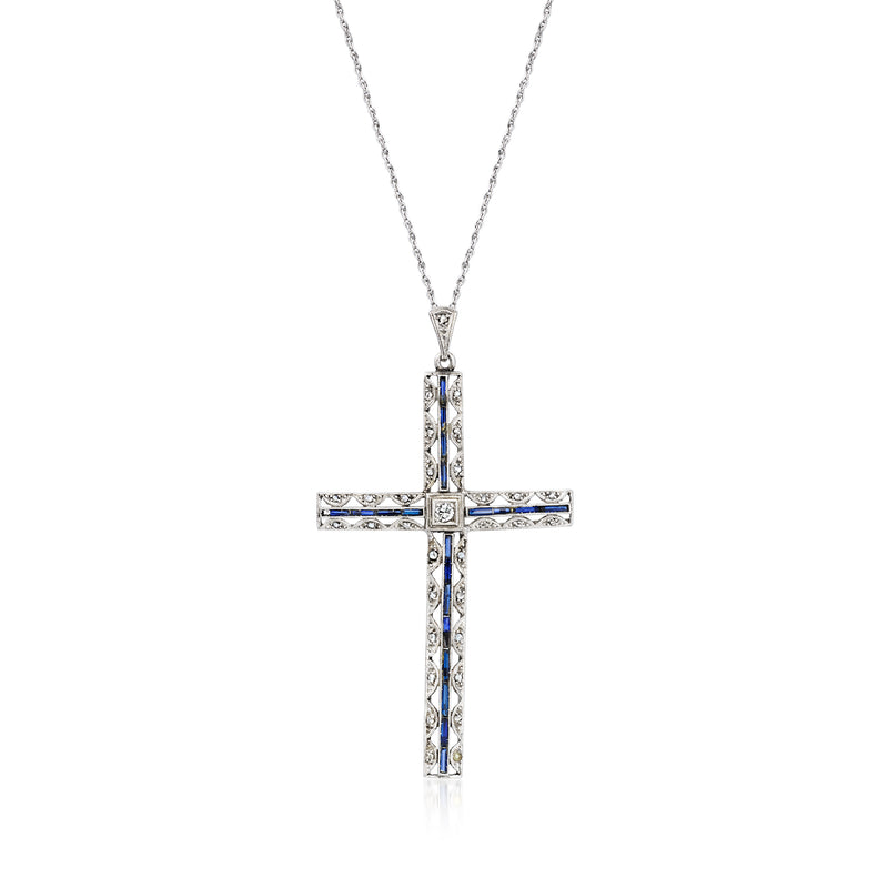Cross pendant necklace with blue sapphire center and diamond-accent border on metal setting