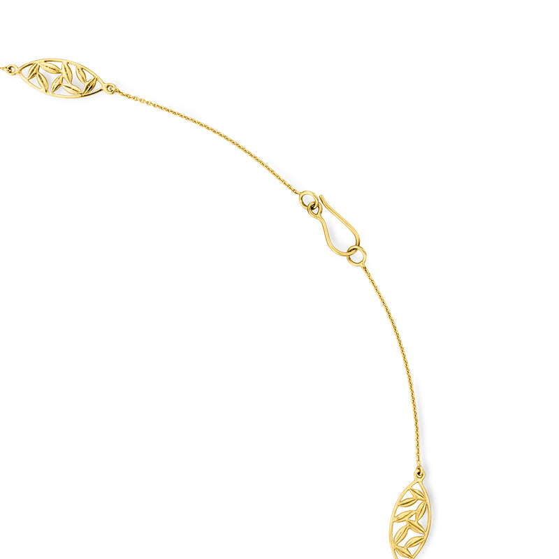 Close-up of 14kt yellow gold station necklace with oval links and clasp