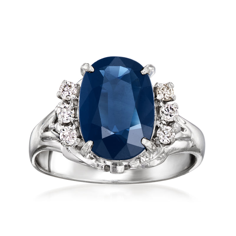 Platinum oval sapphire ring with diamond halo and side clusters