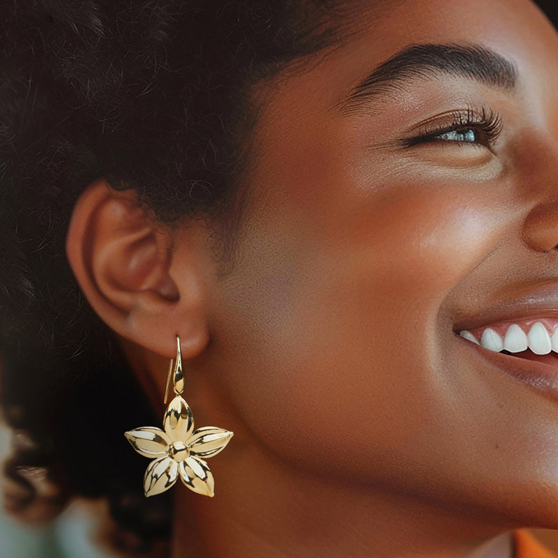 Gold flower drop earwire earrings on model, five-petal star with a round center