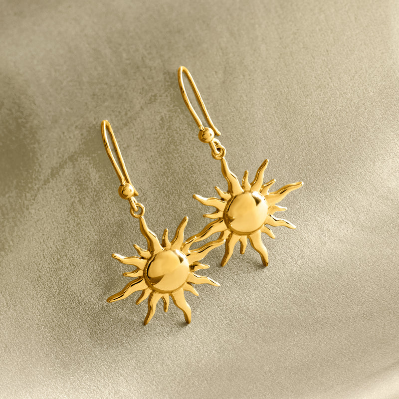 Gold sun drop earrings, pair shown with small chain and textured sun charms