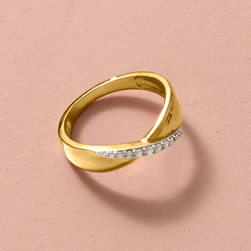Gold ring band with channel-set diamond stones across the top, close-up.