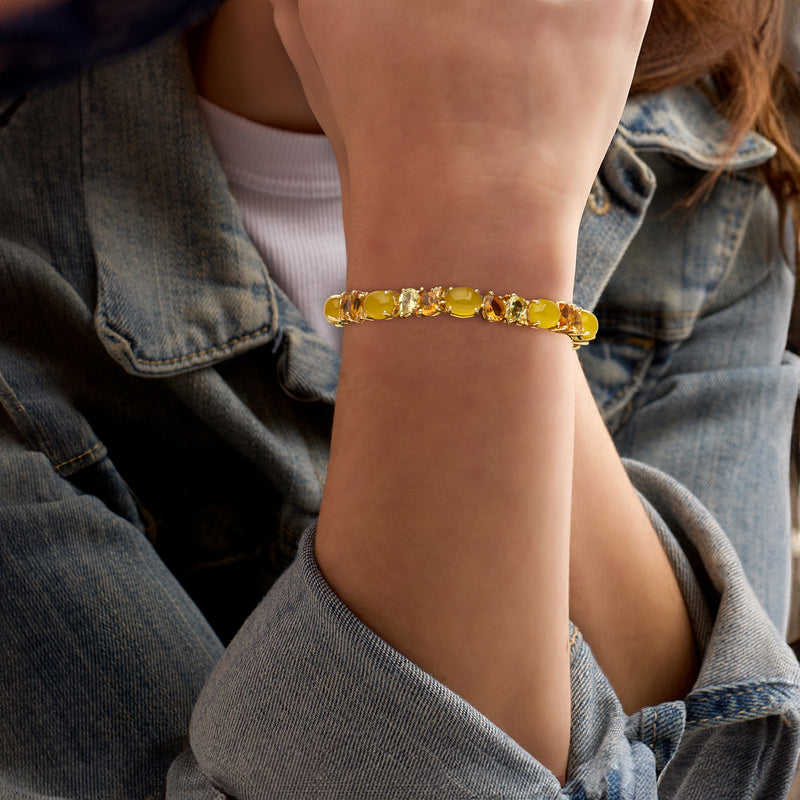 Yellow multi-gemstone bracelet in gold-tone finish worn on wrist