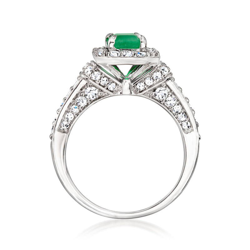 Sterling silver open view ring with emerald-cut green center stone and diamond shoulders.