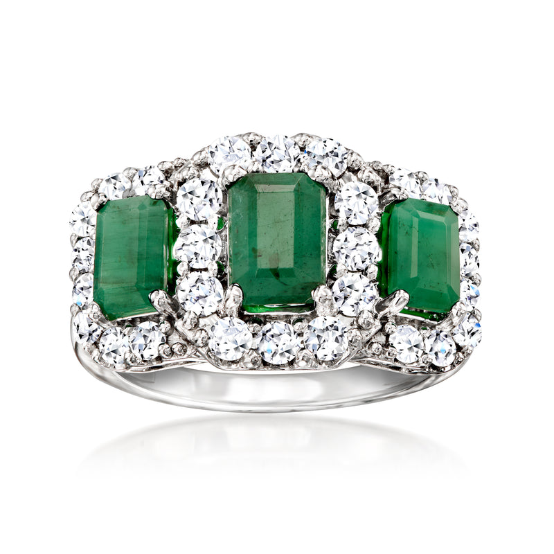 Sterling silver ring with three emerald-cut green gemstones and clear diamond halo
