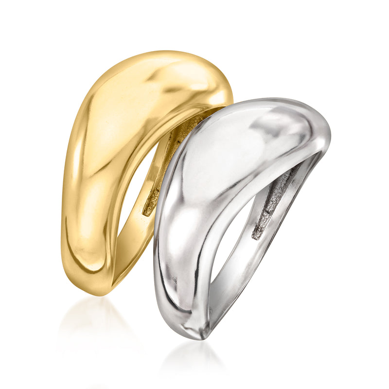 Two-tone sculptural ring set: gold ring behind a polished silver ring, angled view
