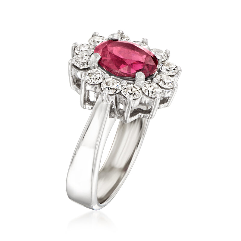 14kt white gold ring with oval red gemstone and diamond side prongs, halo setting