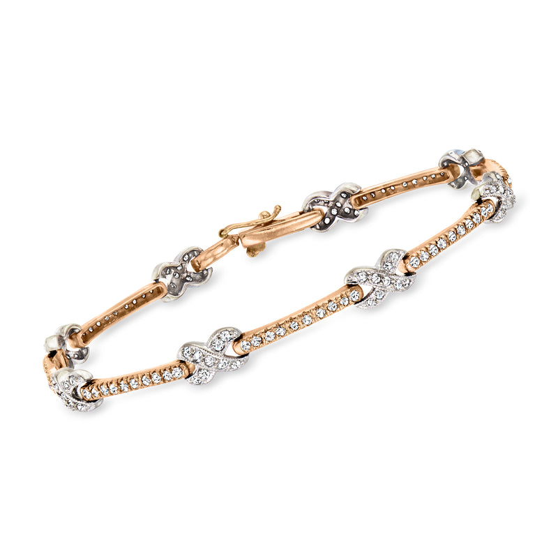 Two-tone gold diamond station bracelet with oval links and X-style center stations