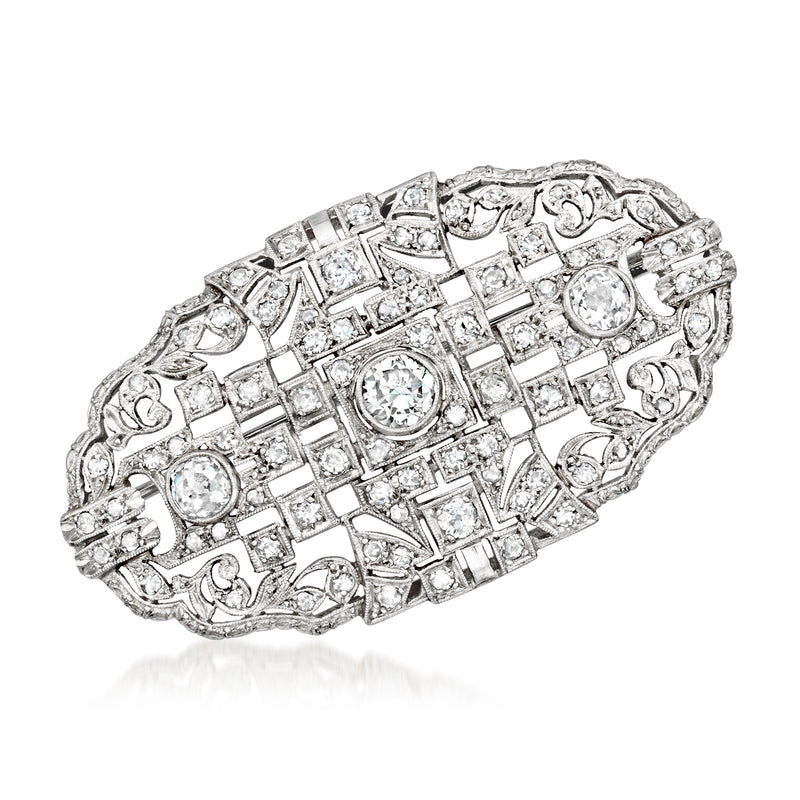 Platinum vintage diamond pin with oval and baguette-cut stones, ornate filigree setting