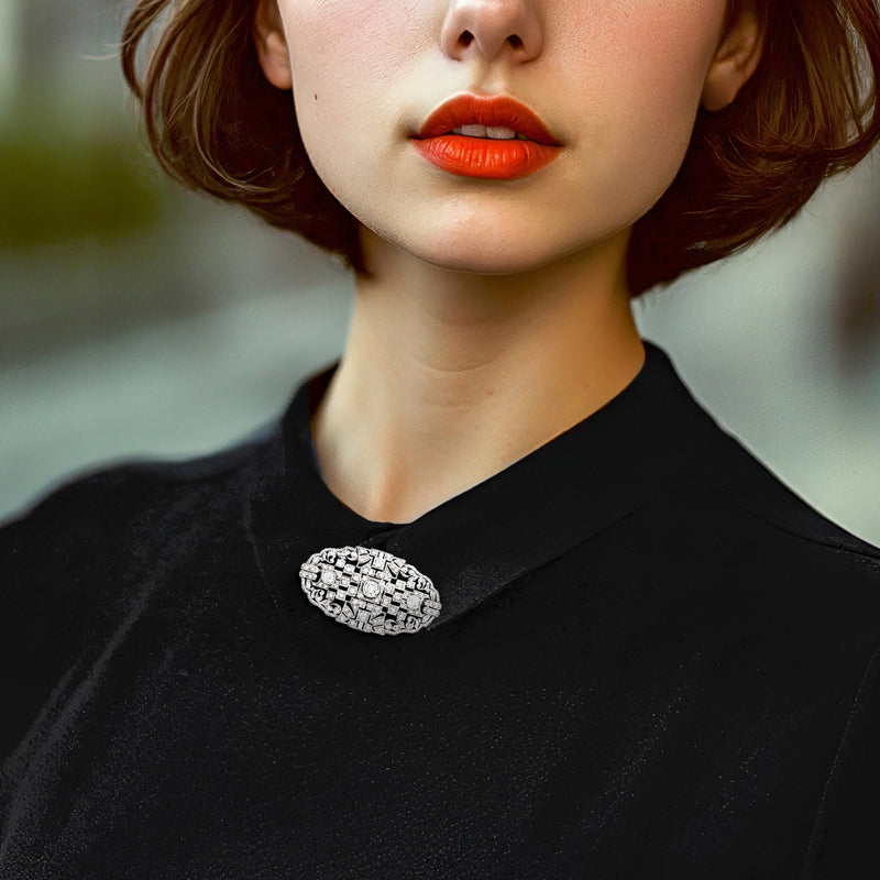 Diamond button pin in platinum worn on black top, textured oval cluster design