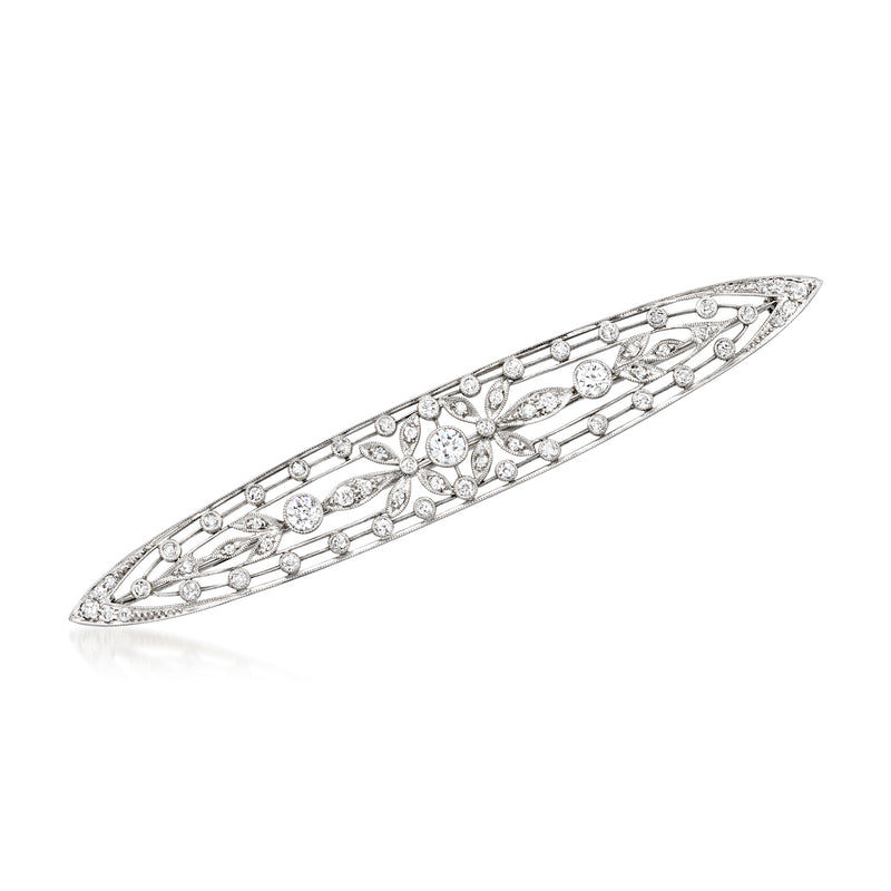 Platinum diamond bar pin with oval row of small stones and central motif