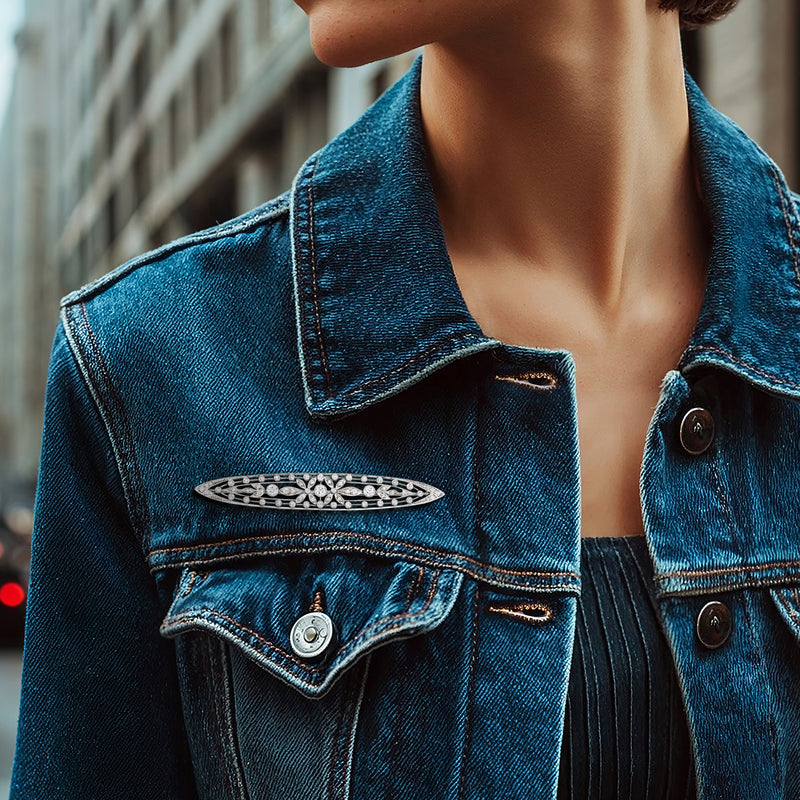Platinum diamond bar pin with row of stones on a blue denim jacket chest pocket