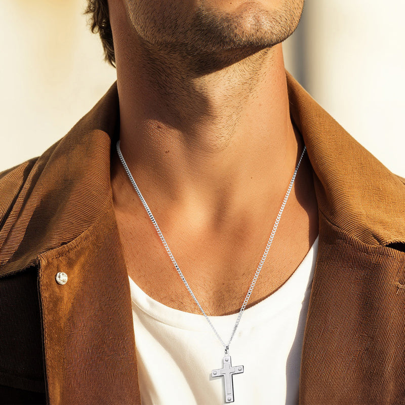 Sterling silver cross pendant necklace worn by man