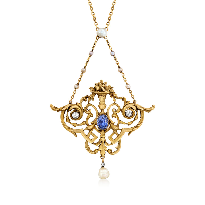 Ornate gold filigree necklace with blue center gemstone, dangling pearls, and pearl accents