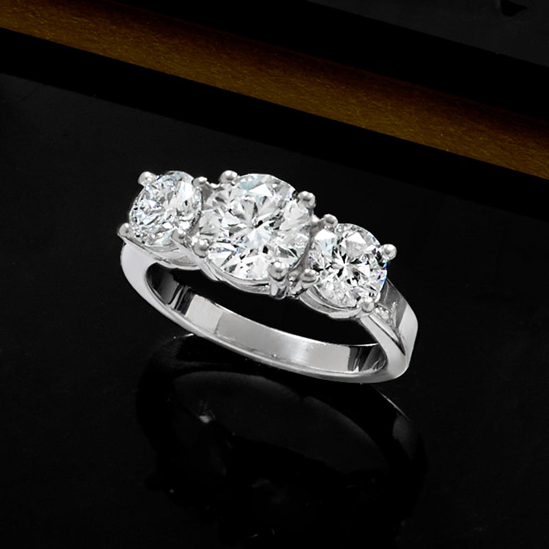 Platinum three-stone lab-grown diamond ring with three round diamonds and high polish