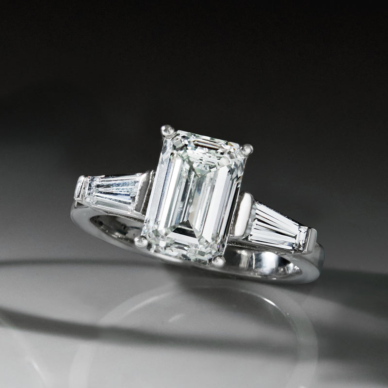 Platinum diamond ring close-up of emerald-cut center with baguette side stones