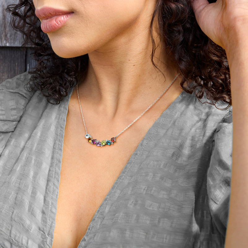 Multicolor gemstone curved necklace on model, delicate sterling silver chain at neckline