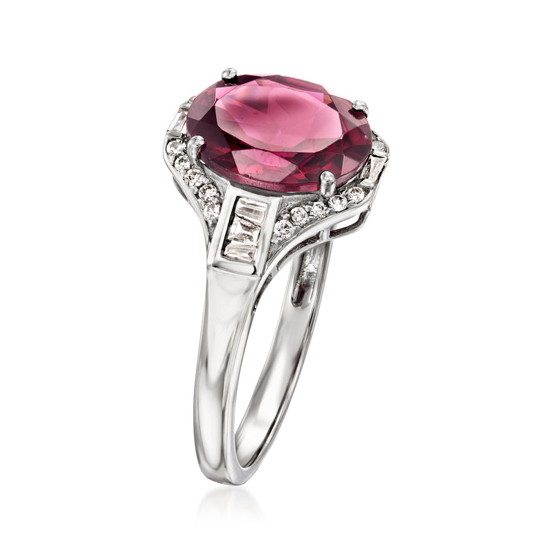 Platinum ring with oval pink-red gemstone and diamond accents, open gallery side