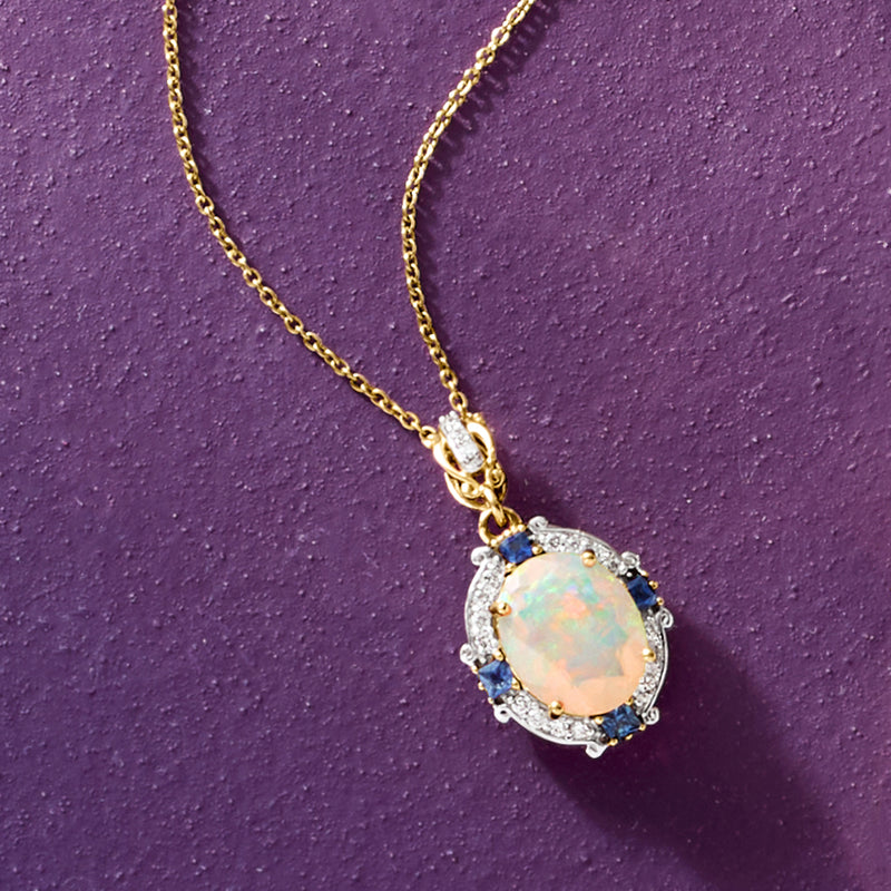 Oval opal pendant necklace in 14k yellow gold with blue sapphire clusters and diamond halo