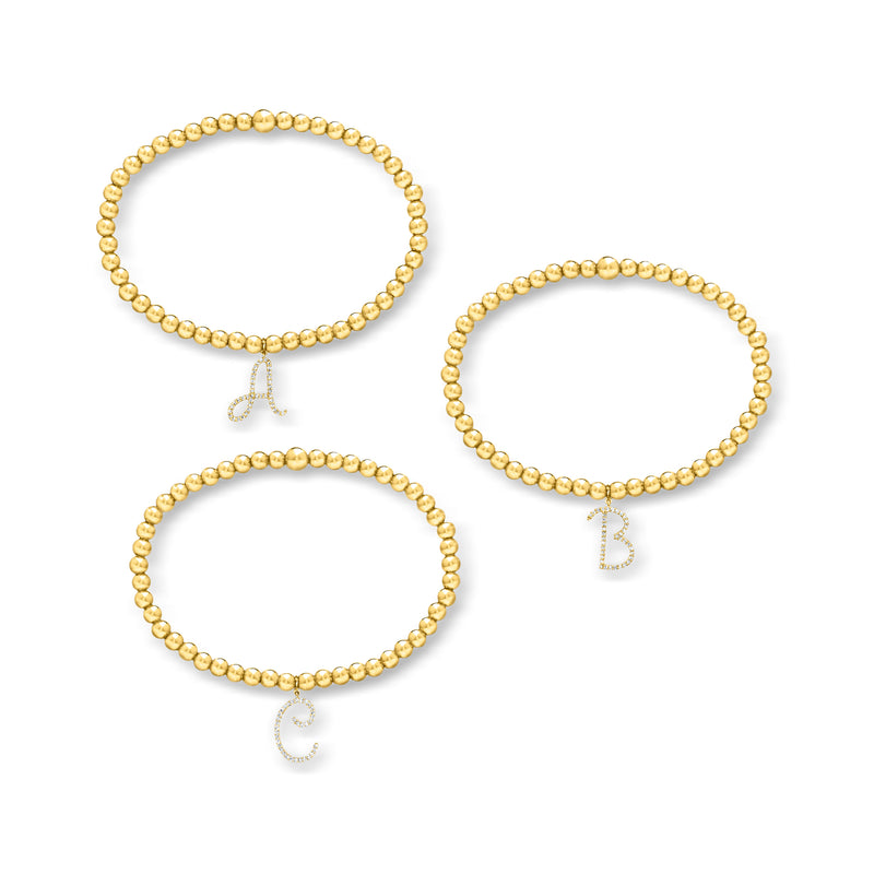 Set of gold bead stretch bracelets with lab-grown diamond initial charms