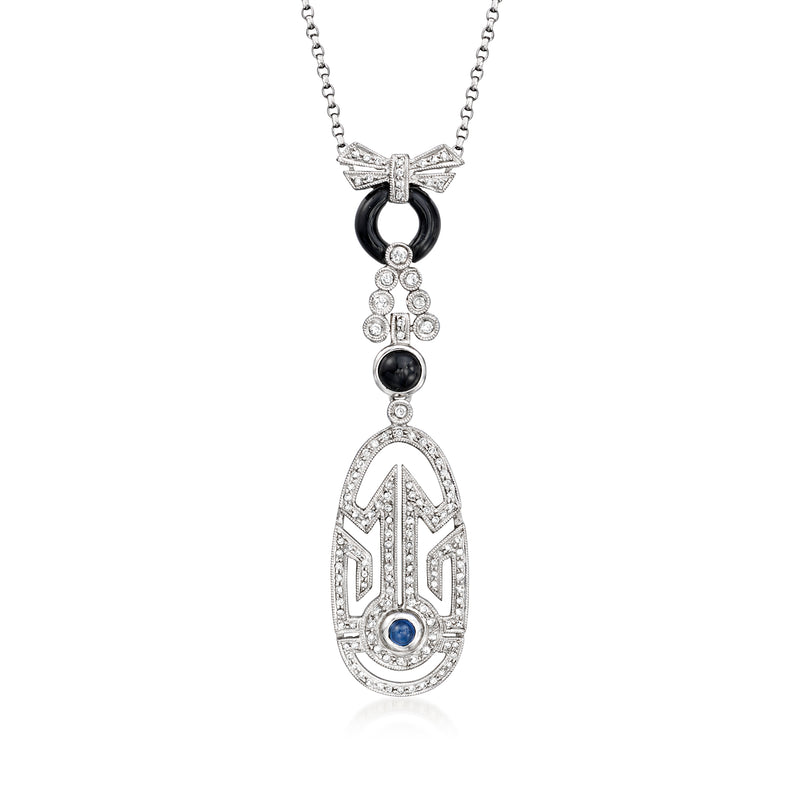 White gold pendant necklace with hamsa-style charm, black center and blue sapphire detail