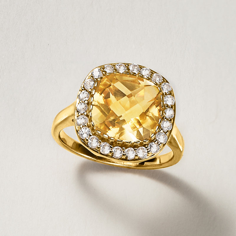 Oval yellow citrine ring with round white topaz halo and gold band