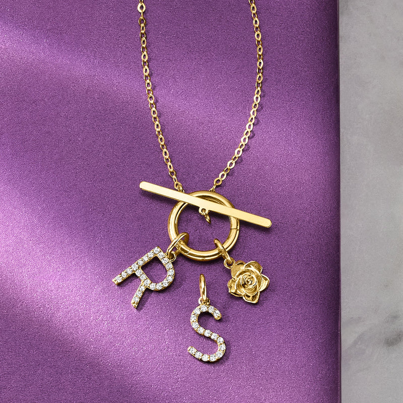 14kt yellow gold toggle necklace with dangling letter, heart, flower, and bar charms