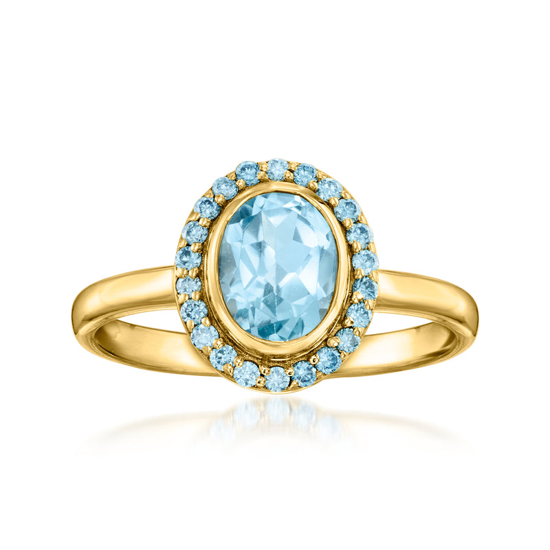 Gold halo ring with oval sky-blue gemstone and round blue stones, slim band