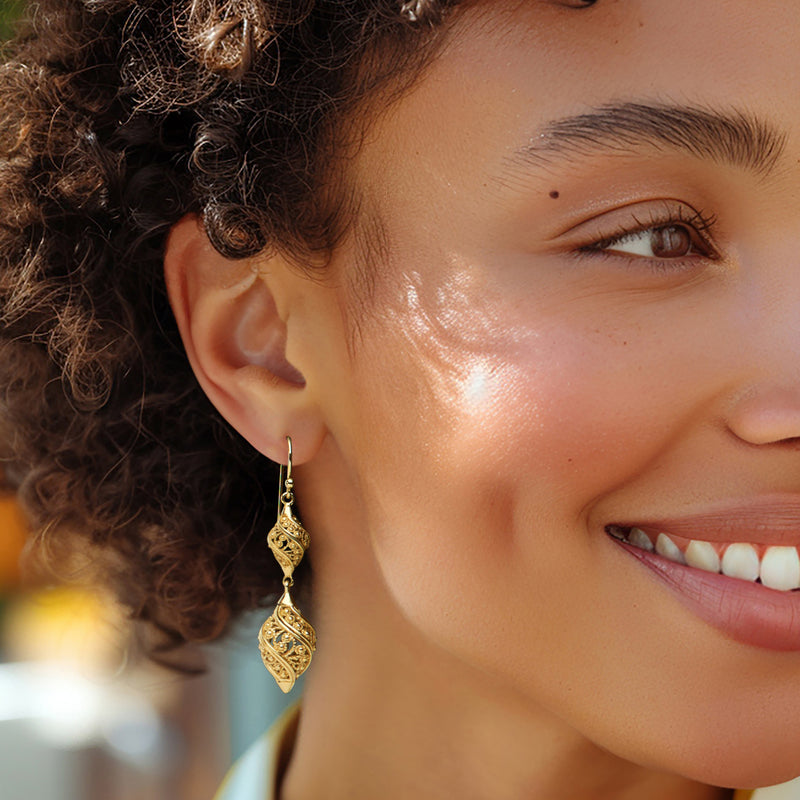 Gold filigree double teardrop drop earrings on earwire, side view