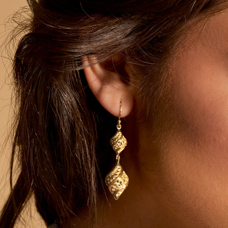 Gold filigree double teardrop drop earring, close-up on earwire