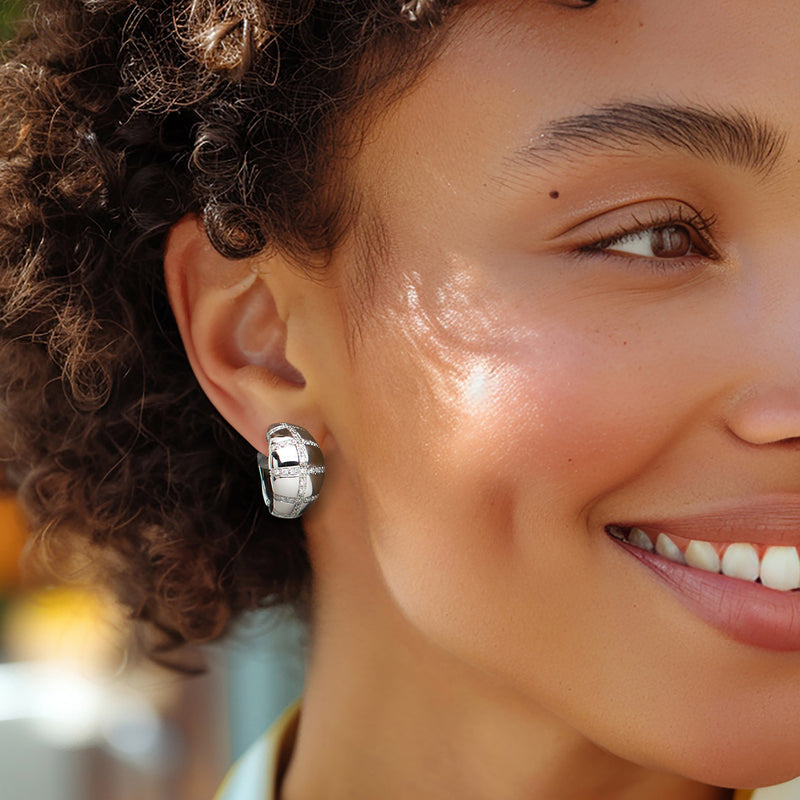 Diamond hoop earrings on ear; white gold hoops with baguette-set front detail