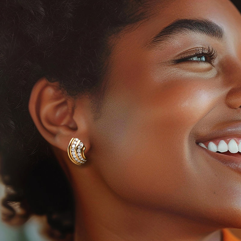 Curved hoop diamond earrings in 14kt yellow gold worn on ear