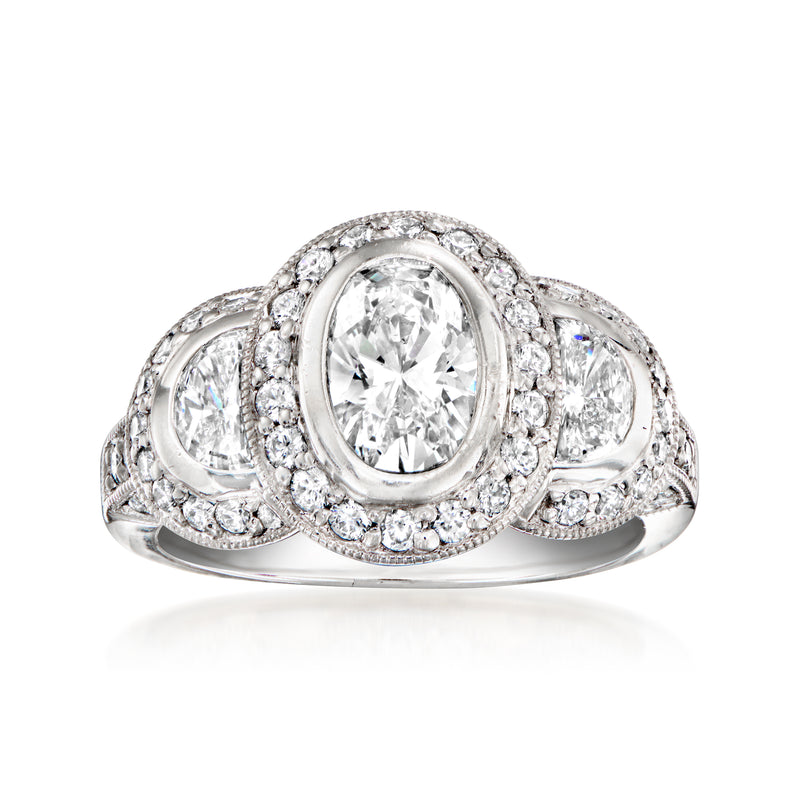 Platinum three-stone diamond ring with oval center and round side stones, halo detail