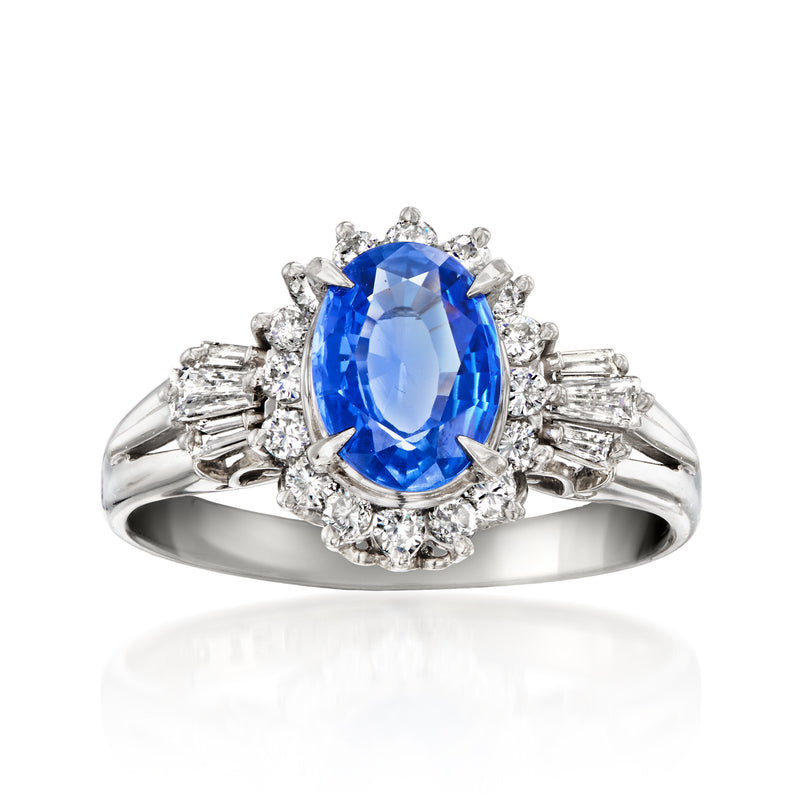 Platinum oval blue sapphire ring with diamond halo and baguette side stones