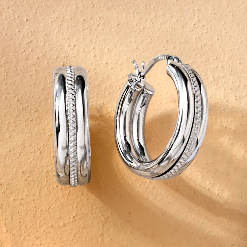 Sterling silver striped hoop earrings, side view with layered rings