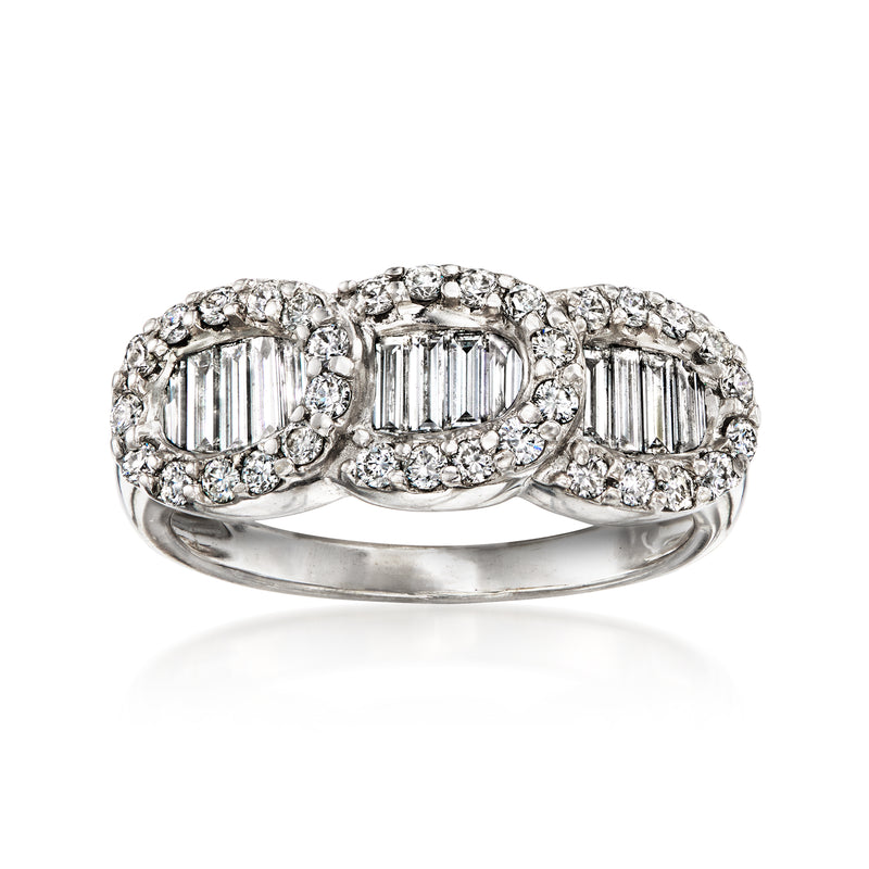 18kt white gold three-stone diamond ring with step-cut center and halo accents